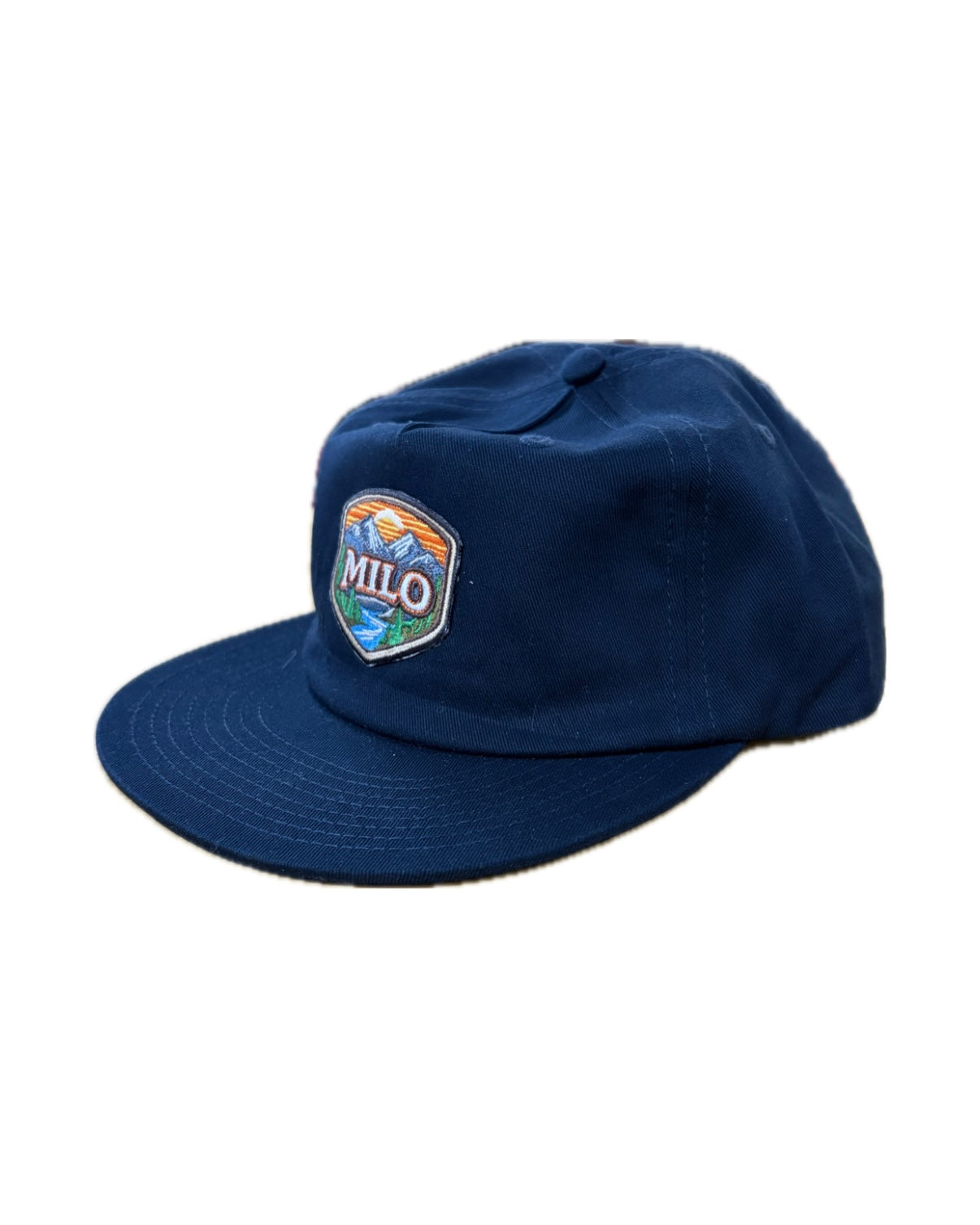 Mens MiloSport Milo Frontier patch hat in navy, showing the adjustable cap with front patch logo and stitched brim.