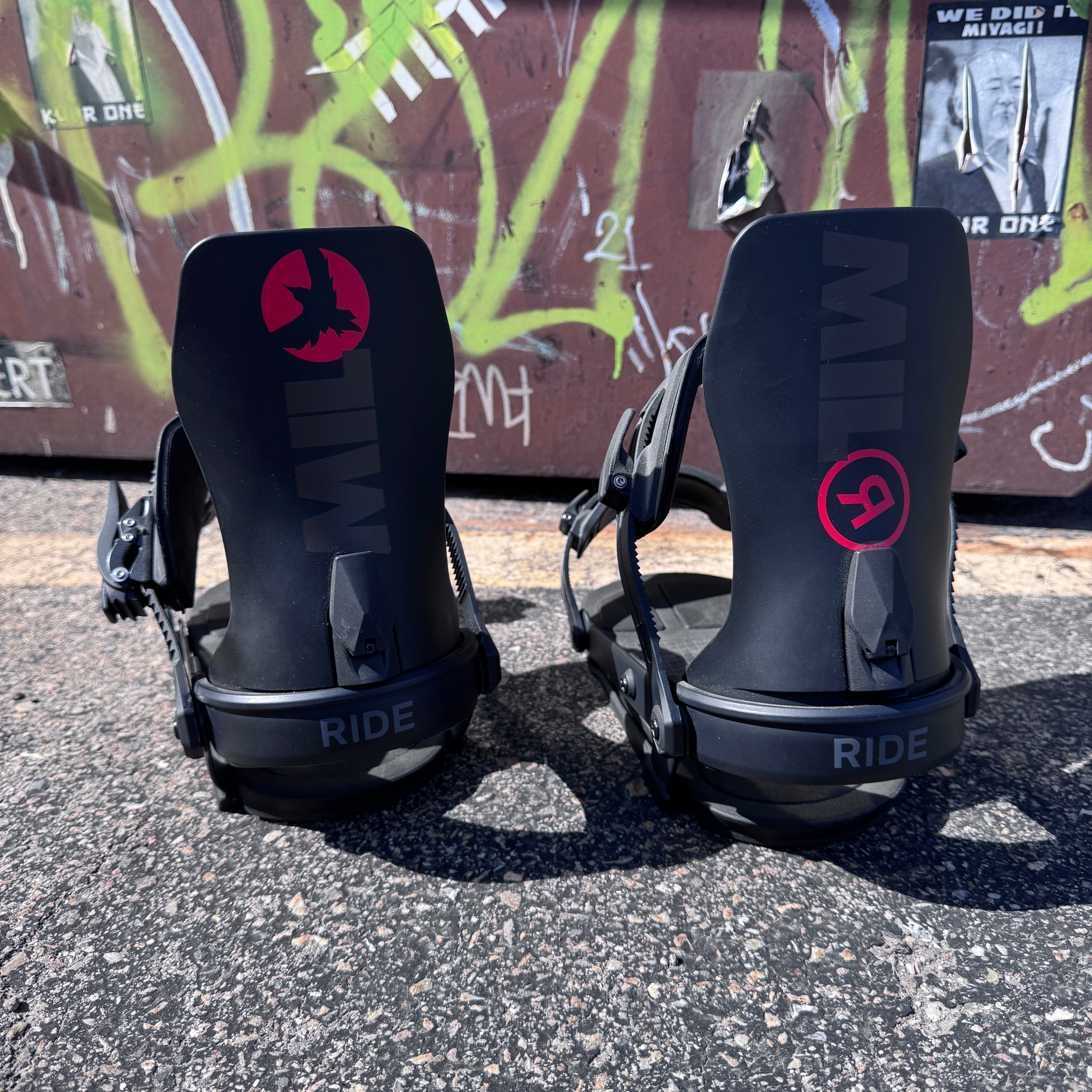 Ride M-9 Snowboard Binding in black mounted on a snowboard, showcasing durable construction and adjustable straps for snowboarding.